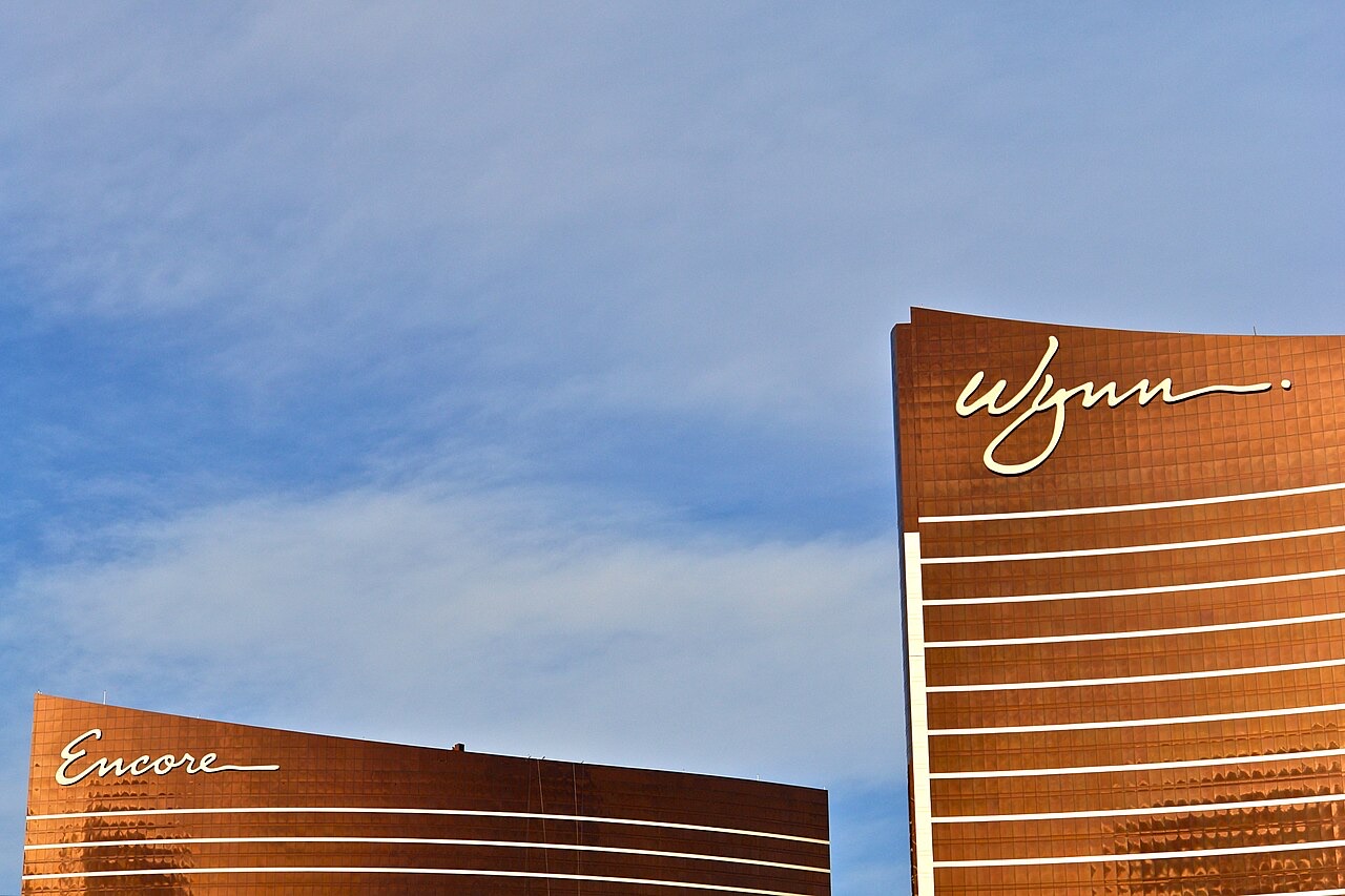 The bronze towers of Wynn and Encore Las Vegas against a blue sky